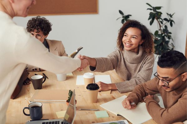 Women shaking hands at meeting